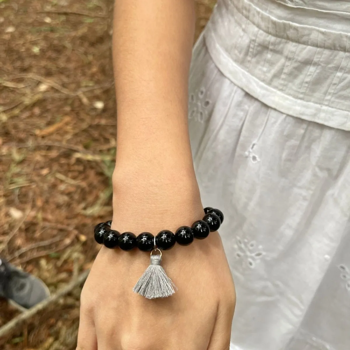 Onyx Bracelet with Tassle to Remind Us that Our Shadows are Parts of Us